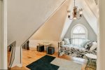Atop the Stairs is a Quiet Common Area with a Day Bed and a Small TV for the Kiddos